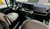 Spacious Mercedes-Benz Sprinter RV rental interior: modern dashboard, steering wheel, infotainment screen, and premium seats.