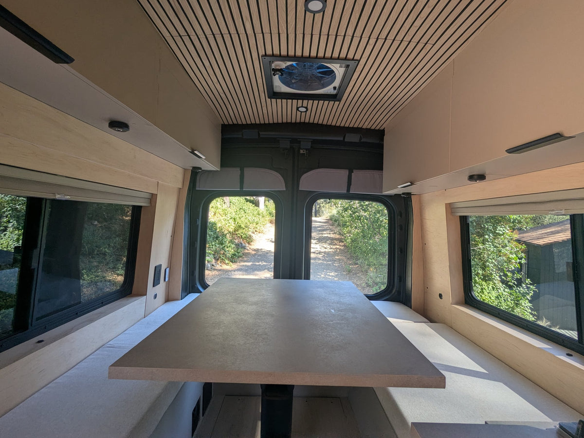  surrounded by nature.|Sleek rv rental interior showcasing a full kitchenette — photo 7