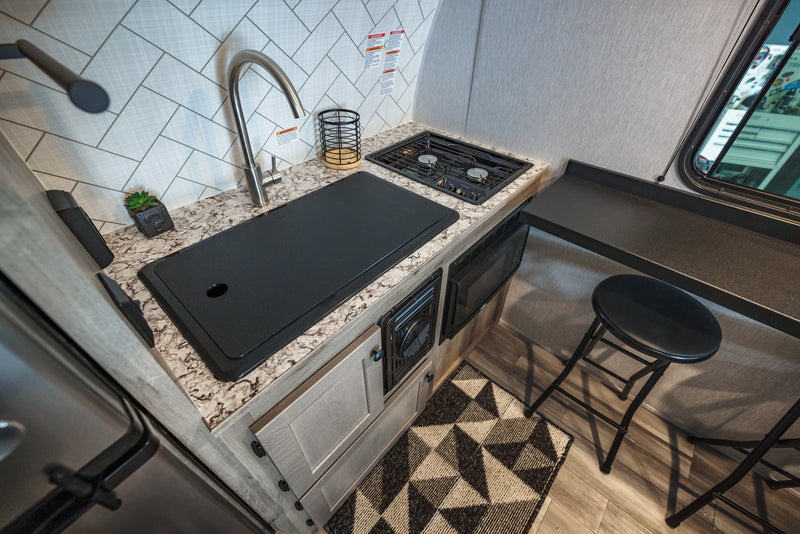  ideal for a comfortable stay.|This RV rental showcases a cozy interior featuring a queen bed — photo 8