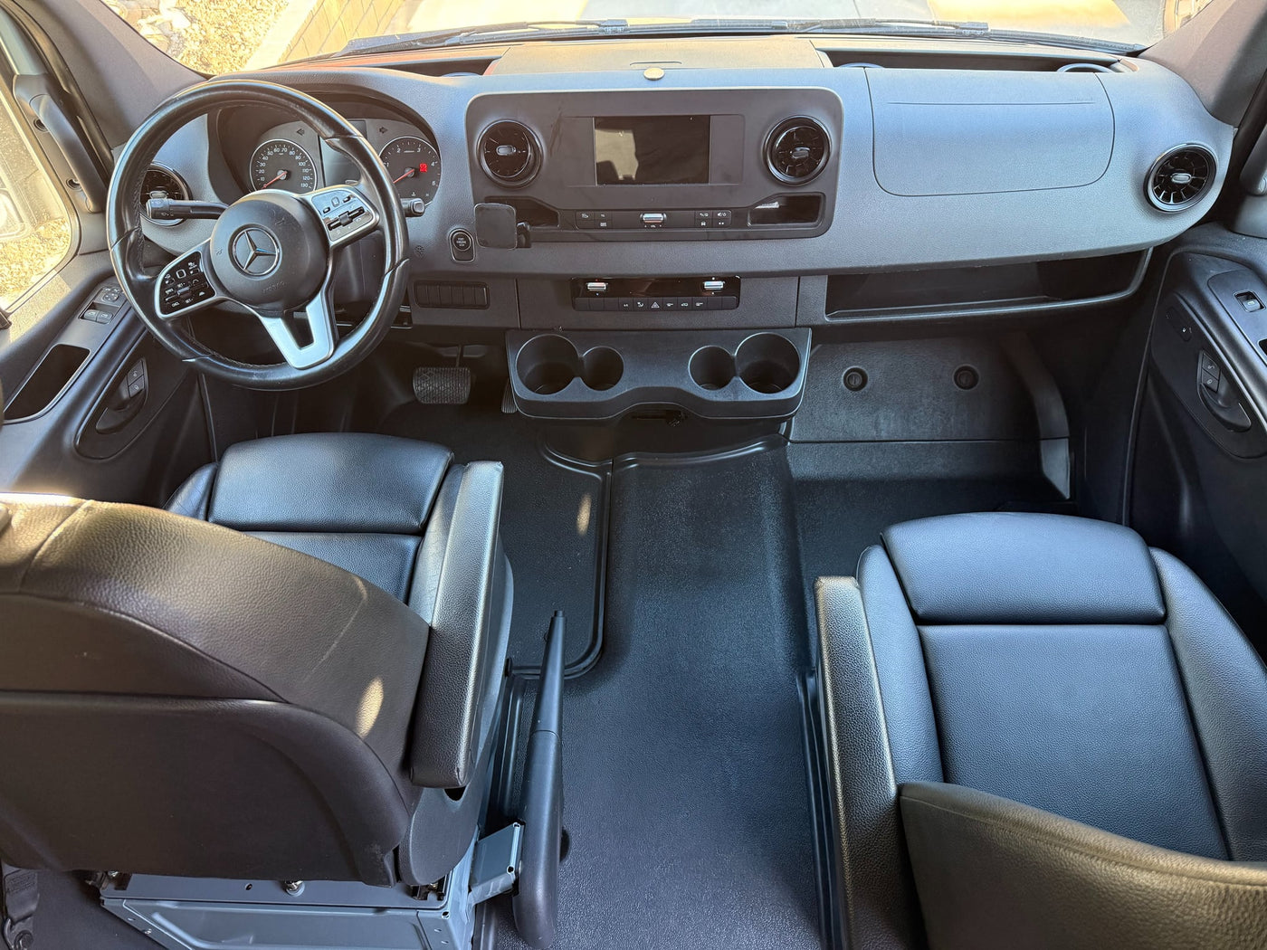  and black passenger seats. Ready for your next adventure.|Spacious RV rental interior with black captain's chairs — photo 5