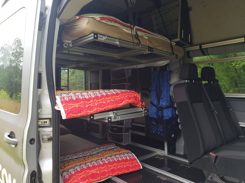  providing compact sleeping and seating for travelers.|Inside an rv rental camper van: passenger seats — photo 6