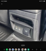 Rear console of an RV rental with USB ports and an AC 110V 150W power outlet, great for charging devices on trips.