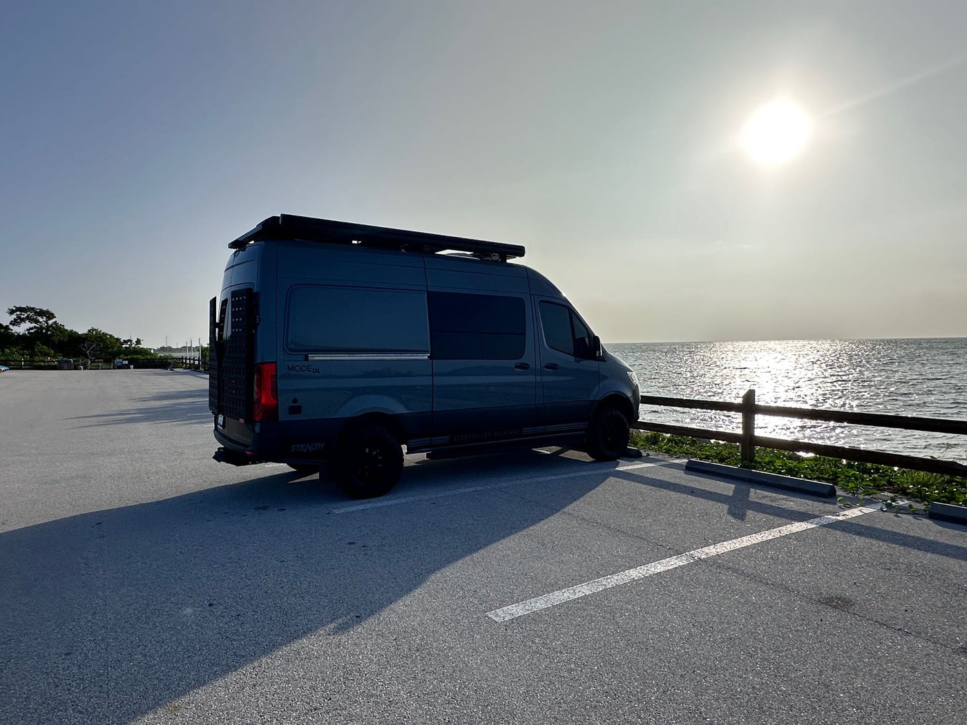  is parked on white gypsum dunes under a clear blue sky.|Gray Mercedes-Benz Sprinter camper van — photo 2