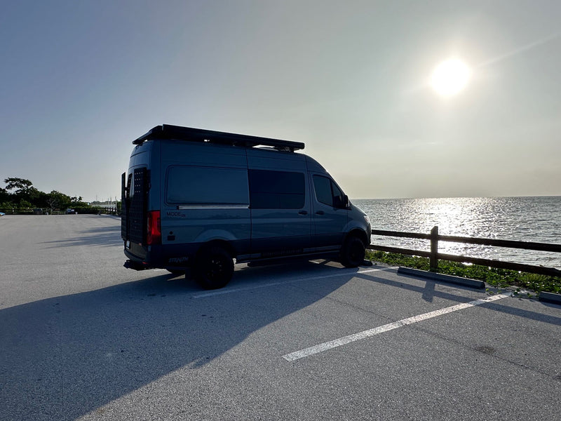  is parked on white gypsum dunes under a clear blue sky.|Gray Mercedes-Benz Sprinter camper van — photo 2