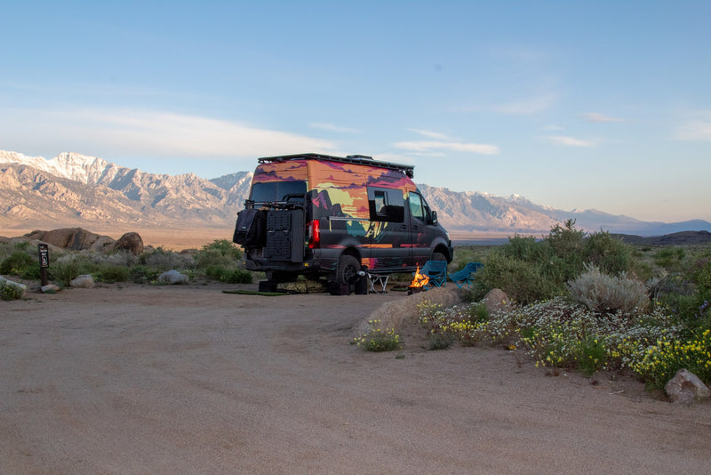  ready for adventure. Campfire glowing with stunning snow-capped mountains behind.|This custom RV rental is set up for desert camping — photo 7