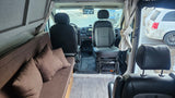Step inside this RV rental, featuring a comfortable sofa bed, swiveling front seats, and a modern dashboard.