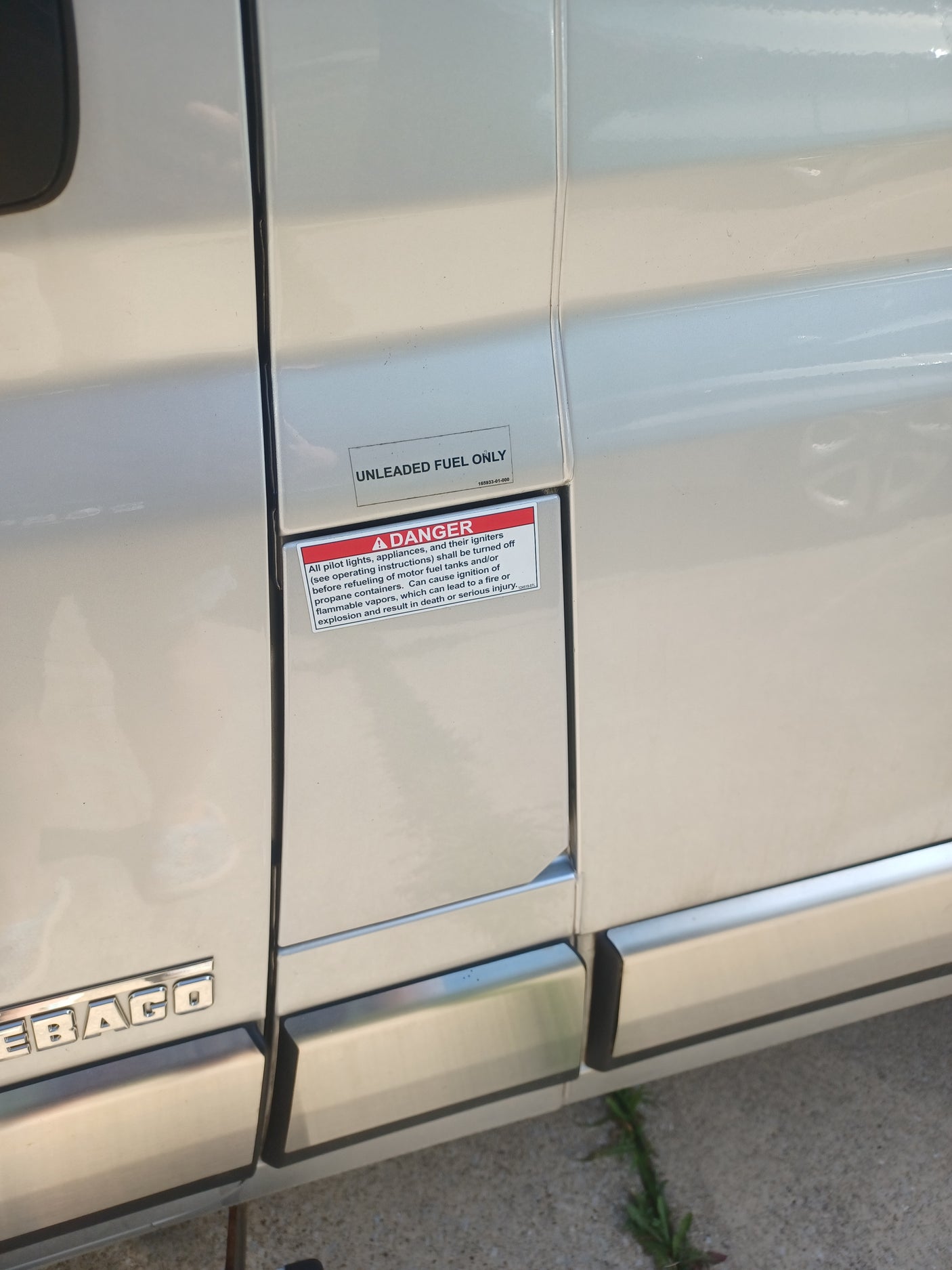 RV rental fuel area shows 'UNLEADED FUEL ONLY' and a DANGER warning about flammable vapors during refueling for safety.