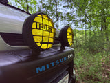 This rugged Mitsubishi SUV with yellow fog lights is ready for forest trails, ideal for your RV rental adventure.