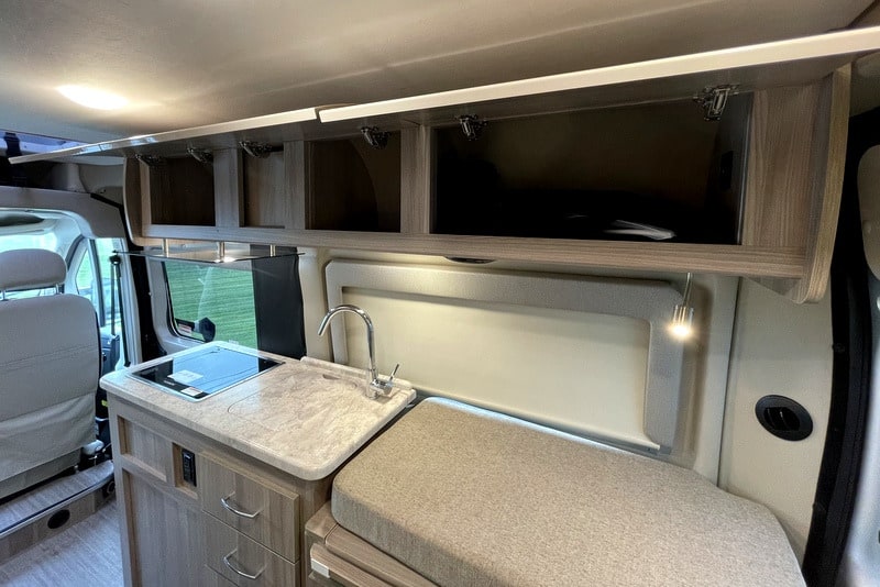  and climate controls.|Spacious RV rental cockpit with beige seats — photo 5
