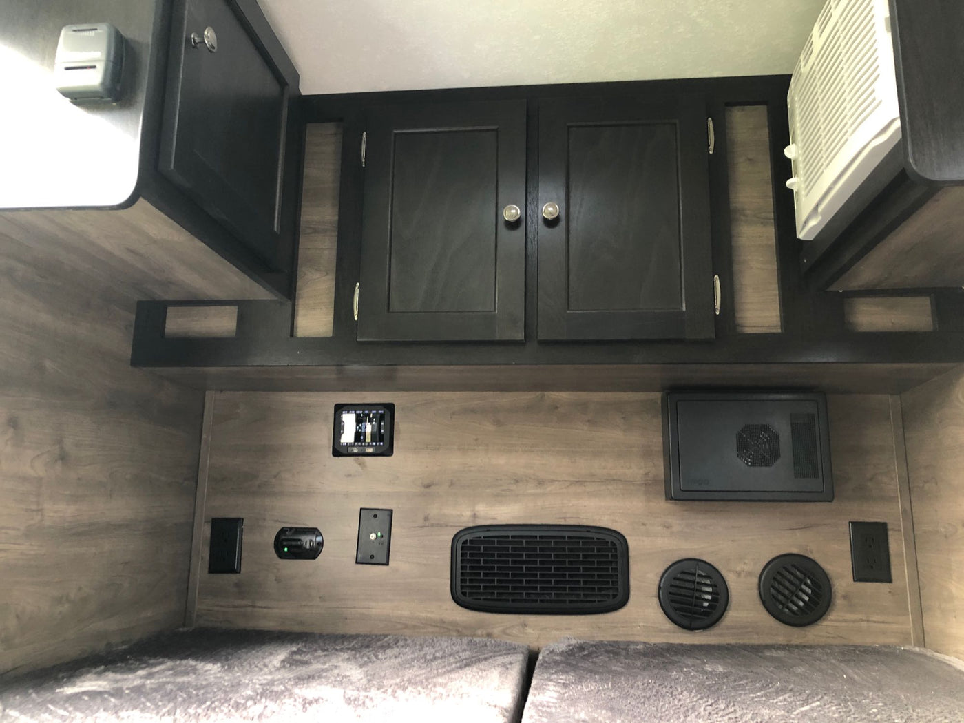 Inside this RV rental: Bunk beds, climate controls, outlets, and storage cabinets for a comfortable stay. — photo 10