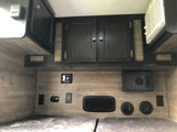 Inside this RV rental: Bunk beds, climate controls, outlets, and storage cabinets for a comfortable stay.