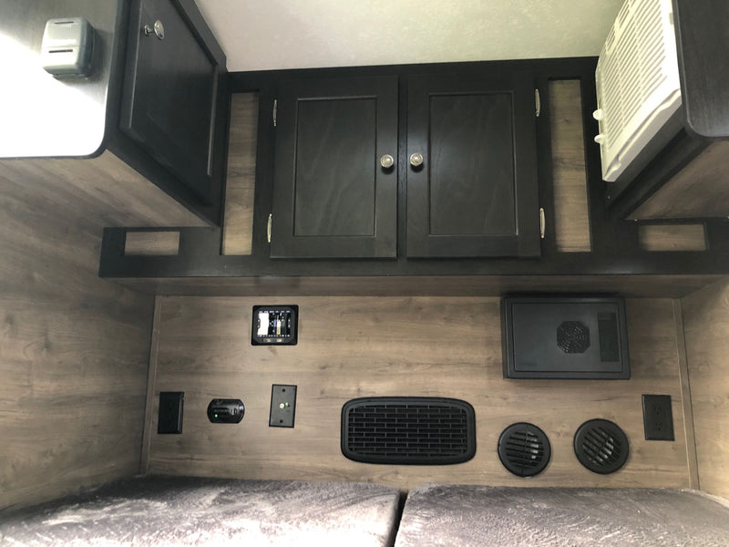 Inside this RV rental: Bunk beds, climate controls, outlets, and storage cabinets for a comfortable stay. — photo 10