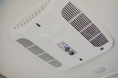 Overhead view of a white Coleman Mach RV air conditioner, essential for comfort in your RV rental.