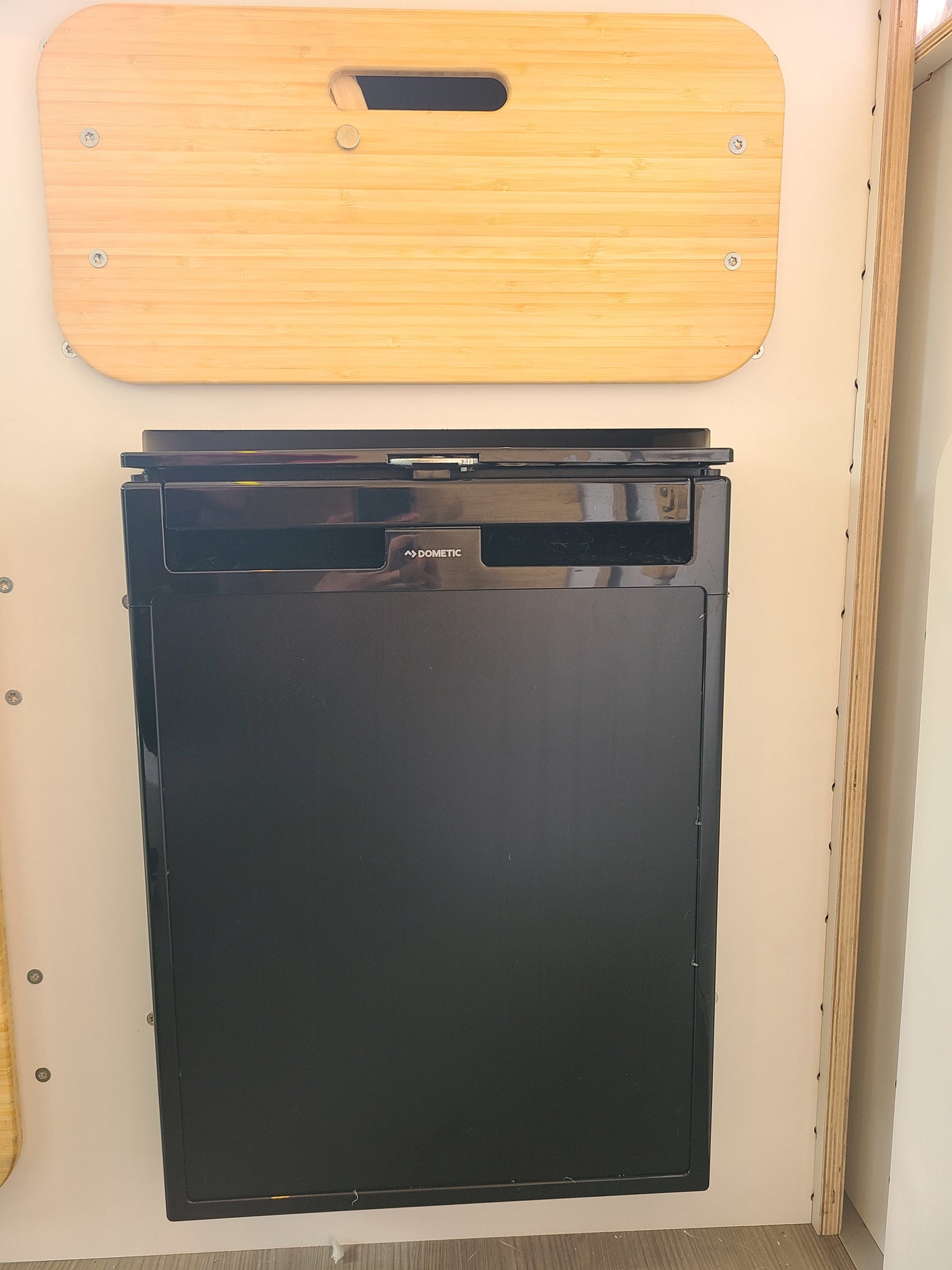 RV rental: Compact Dometic refrigerator installed under a bamboo countertop.