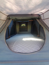 Spacious rooftop tent interior with quilted mattress, ideal for RV rental adventures.