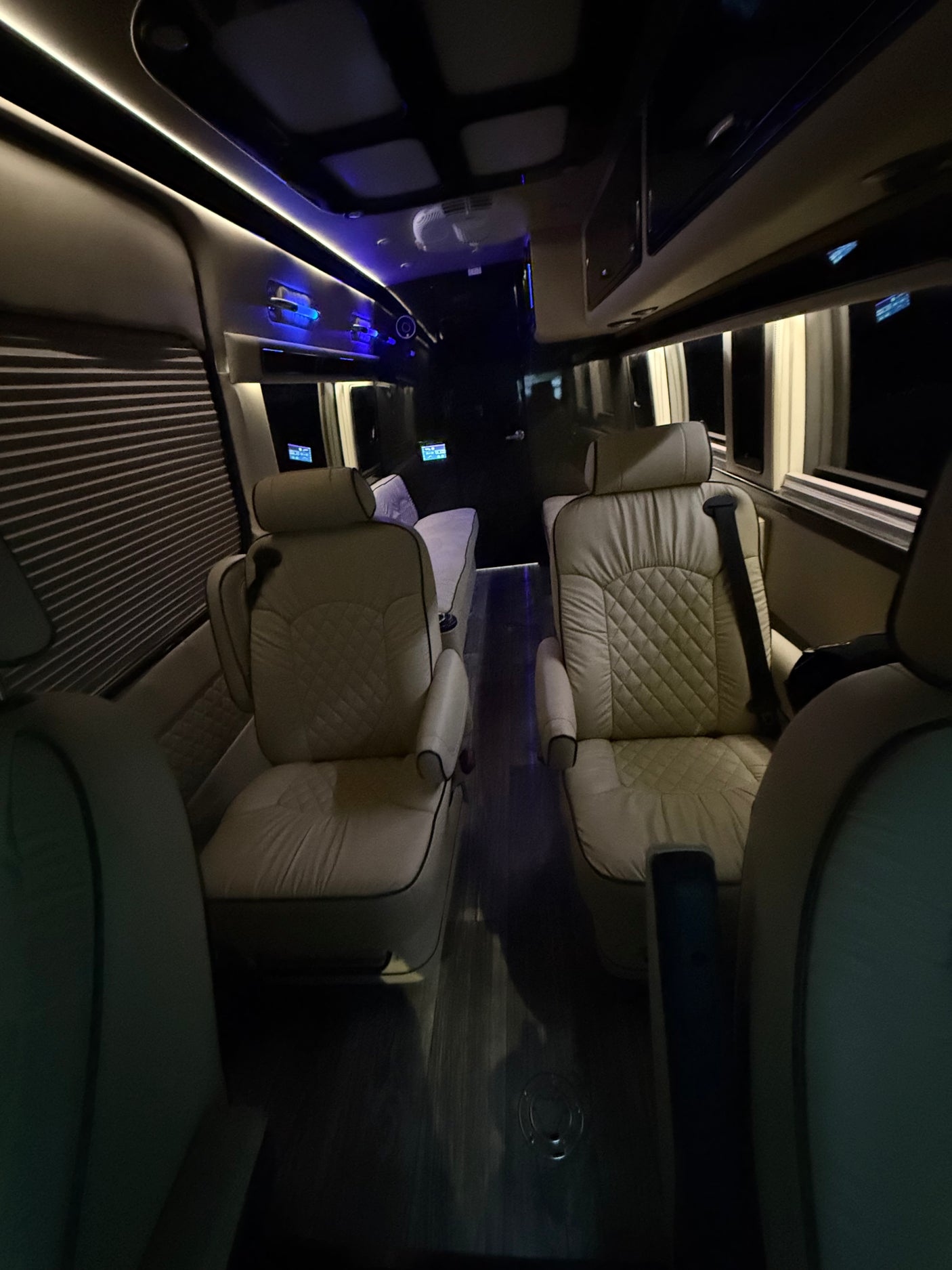 Premium RV rental interior with plush, quilted seats, ambient lighting, and modern design for comfortable travel.