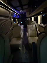 Premium RV rental interior with plush, quilted seats, ambient lighting, and modern design for comfortable travel.