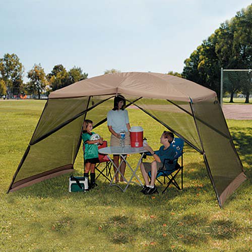 RV rental brings comfort! Family under a portable shade canopy with table & cooler in a park, enjoying an outdoor outing.