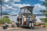 Lakeside RV rental: A teardrop camper with bikes, rooftop tent, and awning for an ultimate outdoor adventure.