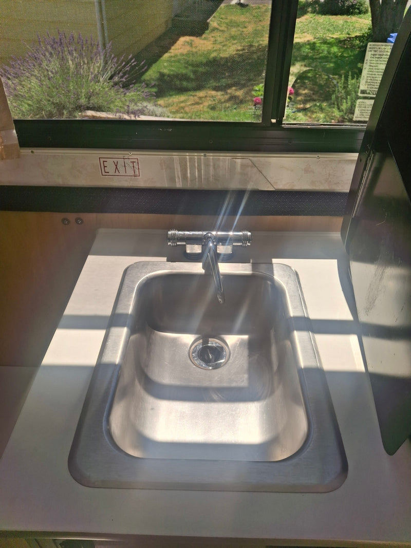  dark cushions & a small cabinet.|Compact kitchen in an rv rental — photo 19