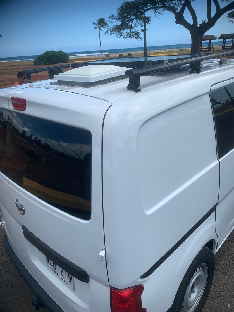  facing beach views. Perfect for car camping and van life.|Camper van interior for your next RV rental. Shows a comfy black bed — photo 11