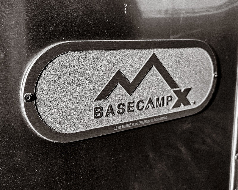 Close-up of a textured BASECAMP X emblem, likely on an Airstream RV rental. Perfect for your next adventure. — photo 7