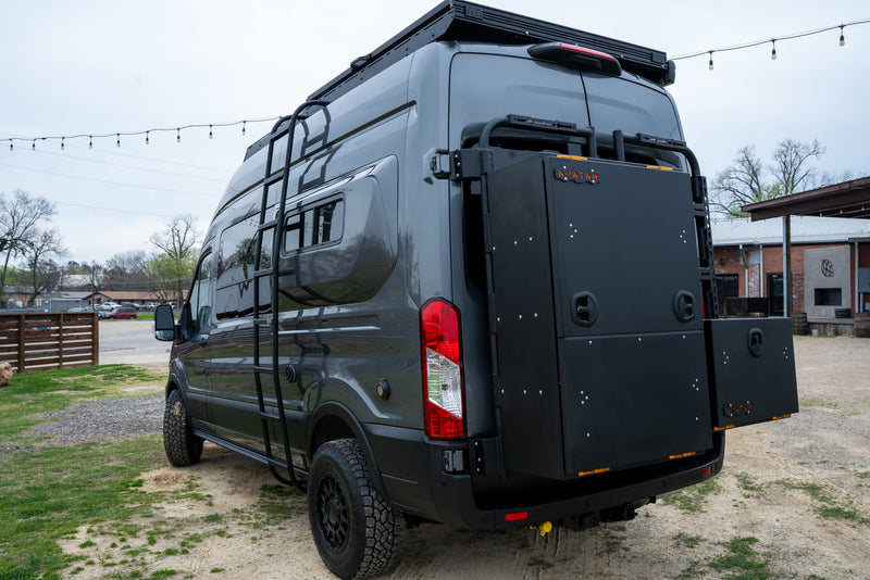 parked on gravel/grass by outdoor lights & buildings.|A sleek — photo 8