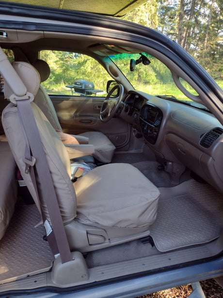 Spacious vehicle interior, ideal for an RV rental, showing tan seat covers, rubber floor mats, ready for outdoor trips.