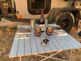 Enjoying an outdoor dinner set up next to an RV rental. Perfect for camping adventures with your Utah Teardrop trailer.