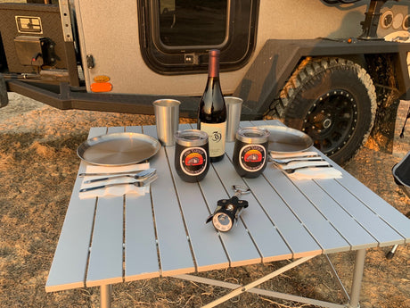 Enjoying an outdoor dinner set up next to an RV rental. Perfect for camping adventures with your Utah Teardrop trailer.