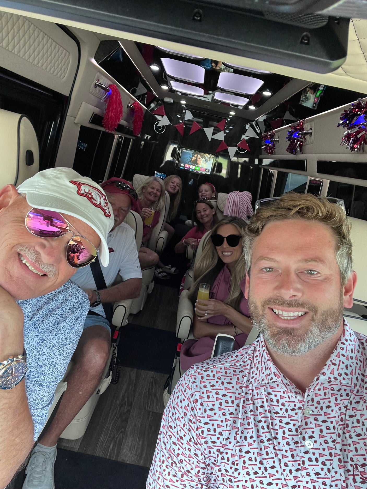 Friends & family travel comfortably in their Arkansas Razorbacks-themed rv rental, ready for game day fun.