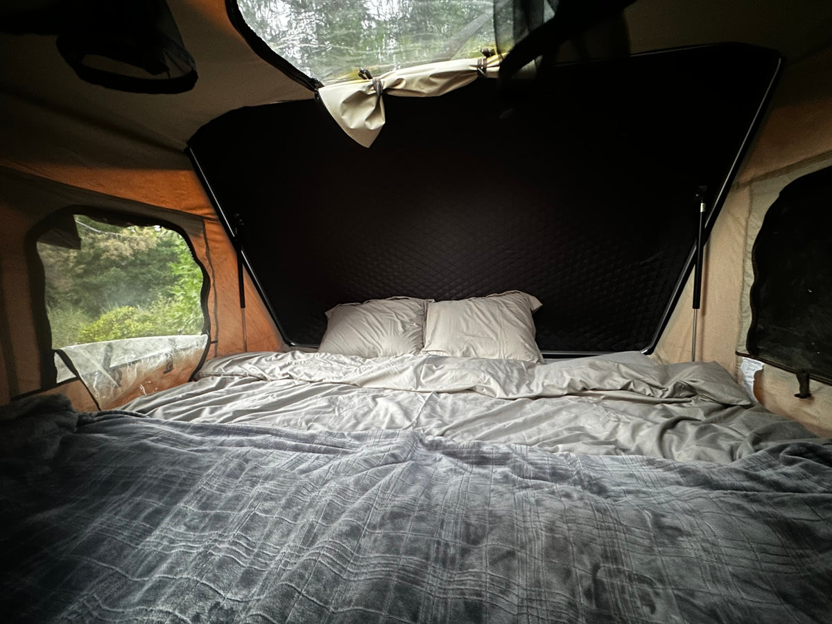 Cozy RV rental pop-up tent features a comfortable bed and immersive nature views for camping. — photo 6