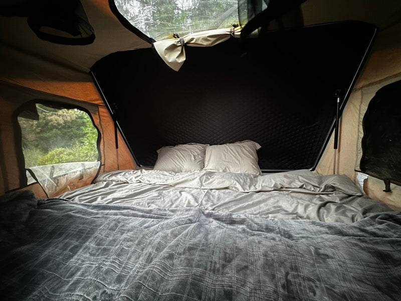 Cozy RV rental pop-up tent features a comfortable bed and immersive nature views for camping. — photo 6