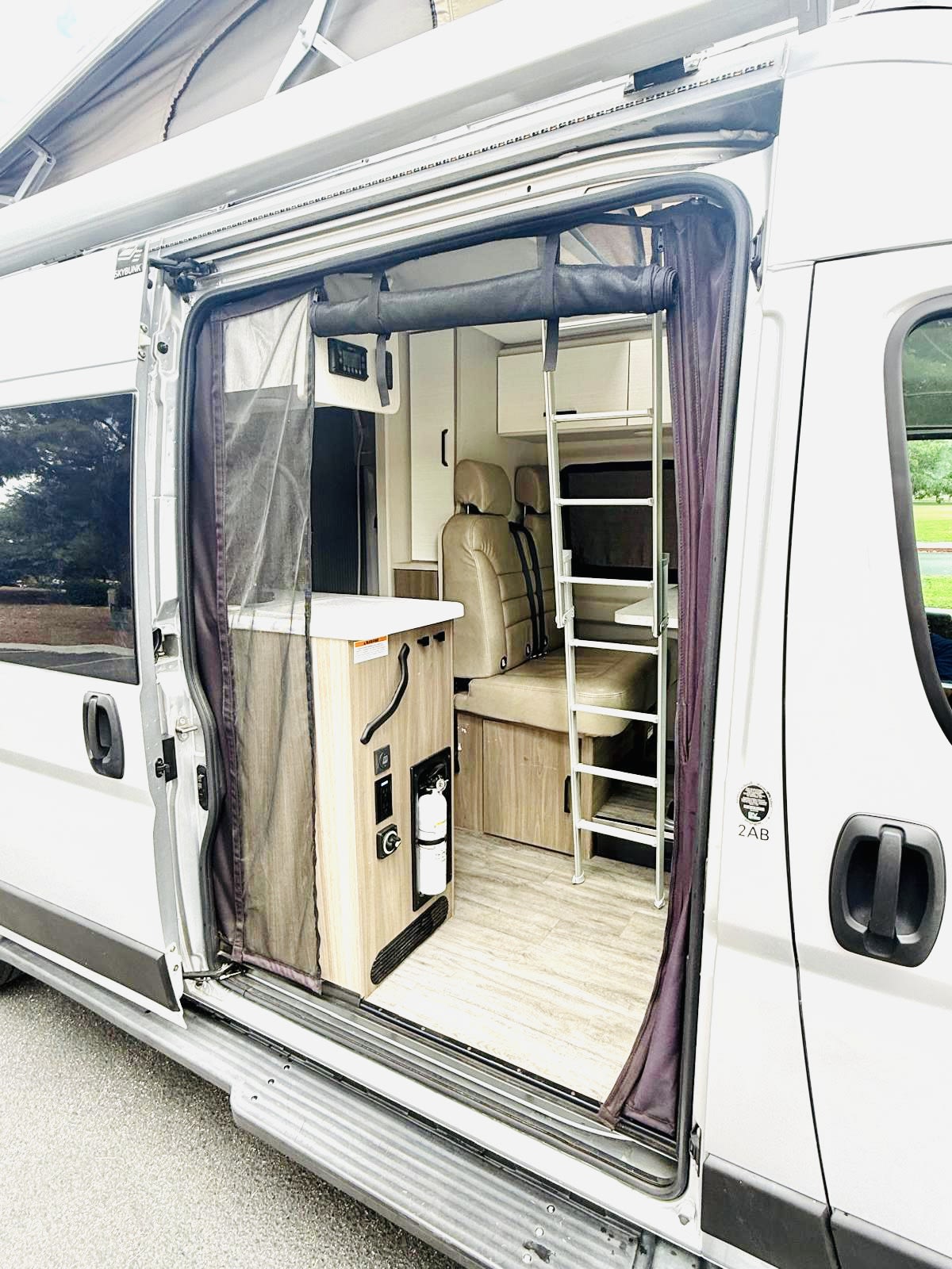  revealing an interior ladder. Ready for your next adventure travel.|Rear view of a white Dazzle rv rental — photo 4