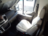 Step inside this RV rental's bright interior. Features include a detailed dashboard, sunshade, and comfortable passenger seating.