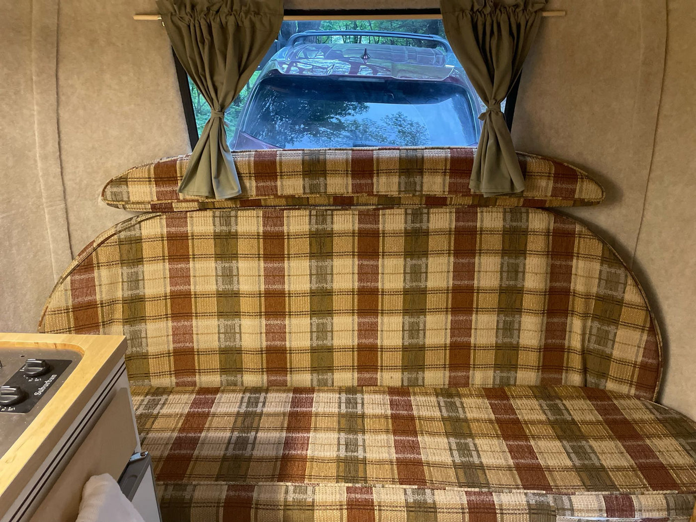  and a scenic forest view outside.|Cozy RV rental interior: A family of four enjoys card games at the dinette — photo 19
