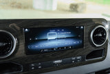 An RV rental's infotainment system: a digital display showing SiriusXM radio, channels, navigation, and media controls.