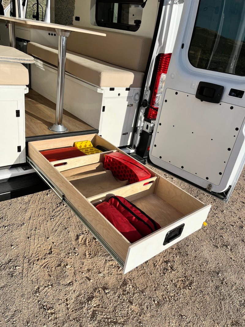 This rv rental features a camper van's rear pull-out drawer with gear. Its interior boasts bench seating and smart storage solutions. — photo 18