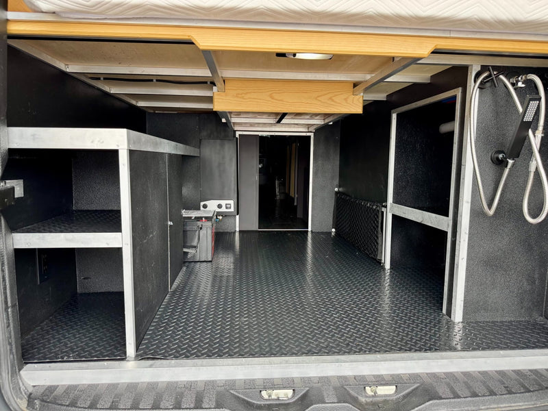  and cozy wooden accents.|White Mercedes Sprinter RV rental covered in snow — photo 5