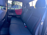 Comfortable rear seats inside a vehicle, ready for your RV rental. Rain-kissed window reveals a tropical landscape.
