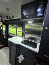  equipped with an extended side awning and rear-mounted spare tire