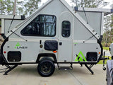 Light grey A-Liner A-frame pop-up camper. This compact travel trailer, great for an RV rental, is ready for outdoor adventures.