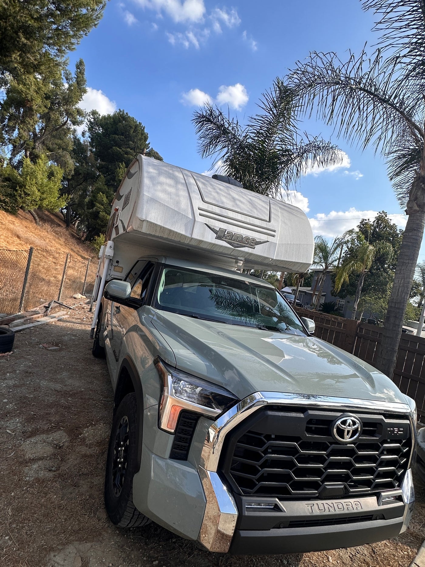  ideal for your next RV rental adventure.|Grey Toyota Tundra truck with a Lance truck camper — photo 11