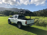 Explore Hawaii's beauty! White Tacoma truck with a Tuff Stuff rooftop tent, ready for your RV rental adventure in the mountains.