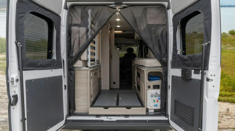  and mesh-covered rear doors with scenic views.|RV rental's cozy pop-up bed offers a tranquil lake view. Complete with grey quilted bedding — photo 9