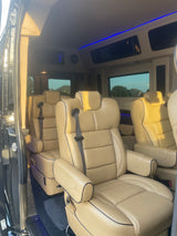 RV rental interior: Cream leather captain's chairs, ambient blue lights, and spacious design for ultimate travel comfort.
