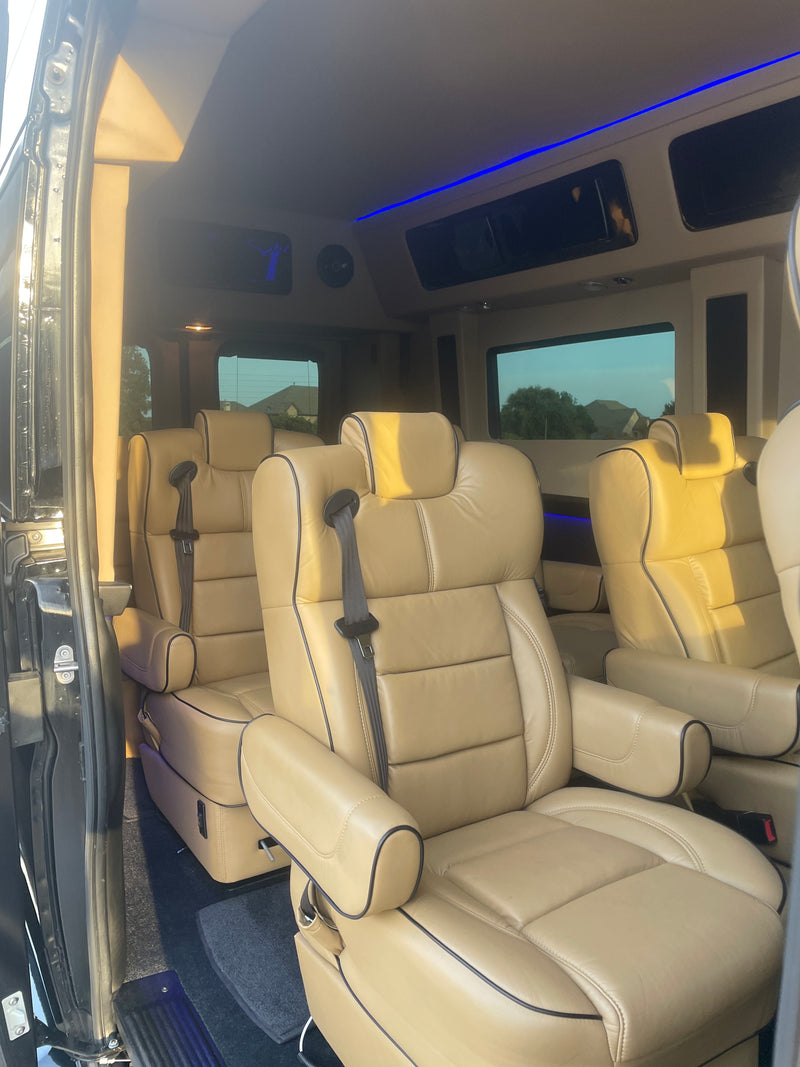 RV rental interior: Cream leather captain's chairs, ambient blue lights, and spacious design for ultimate travel comfort. — photo 5