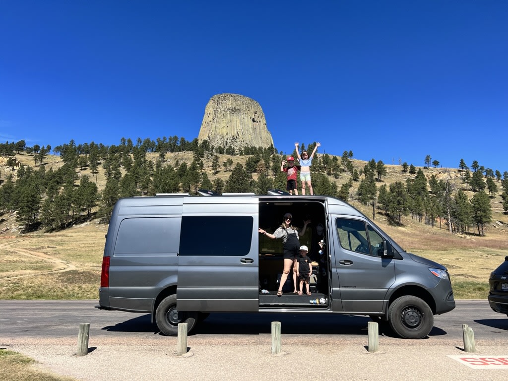  provides a cozy campsite setup.|Inside a custom RV rental camper van