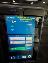 An RV rental's digital climate control screen, set to 72°, shows cool mode options and a warning about ignition.