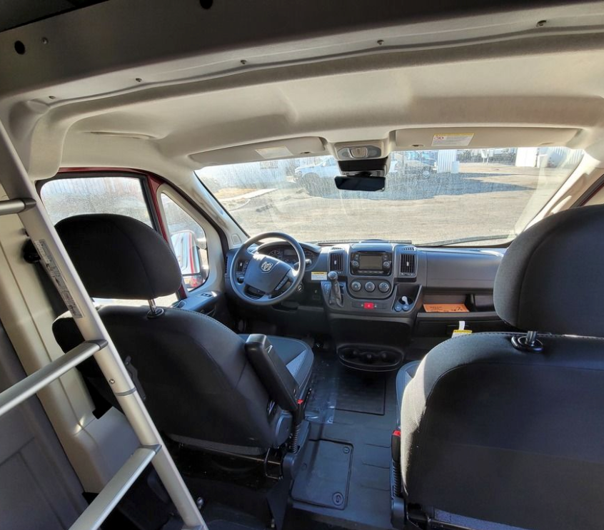 Inside a spacious RV rental van, showing the clean front cabin, dashboard, and seating, ready for adventure.